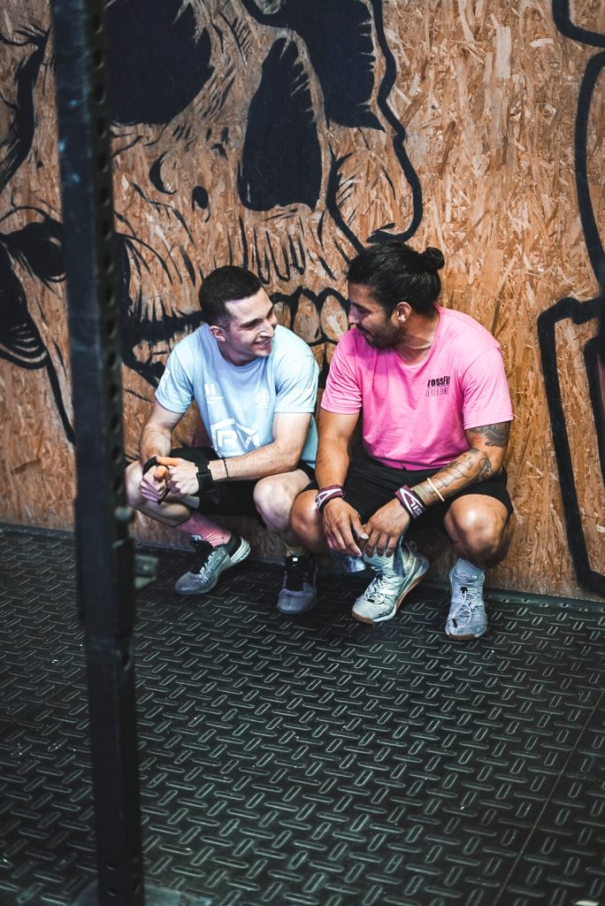 Two CrossFit Puerto Banús athletes resting beside the skull wall